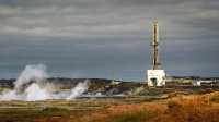 Geothermie-Kraftwerk Reykjanesvirkjun in Island mit hellblauem Abwassersee im Lavafeld